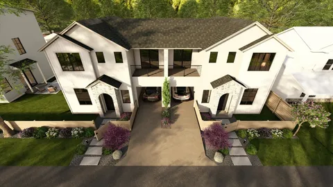 a view of a white house with many windows and yard