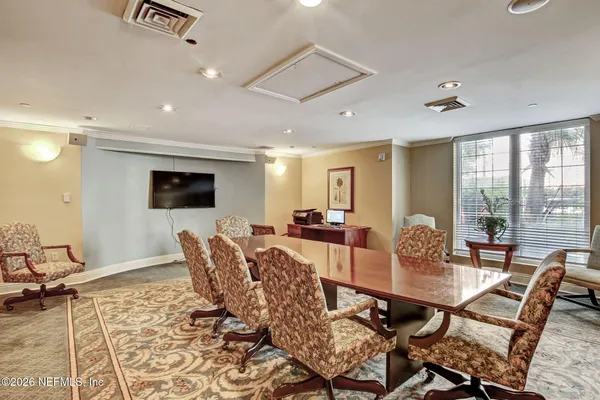 a room with furniture pool table and windows