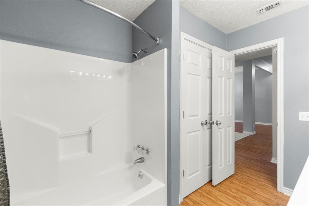 2917 Harlow Road Commerce, TX 75428 - Photo 22 of 40 a bathroom with a bathtub and a shower