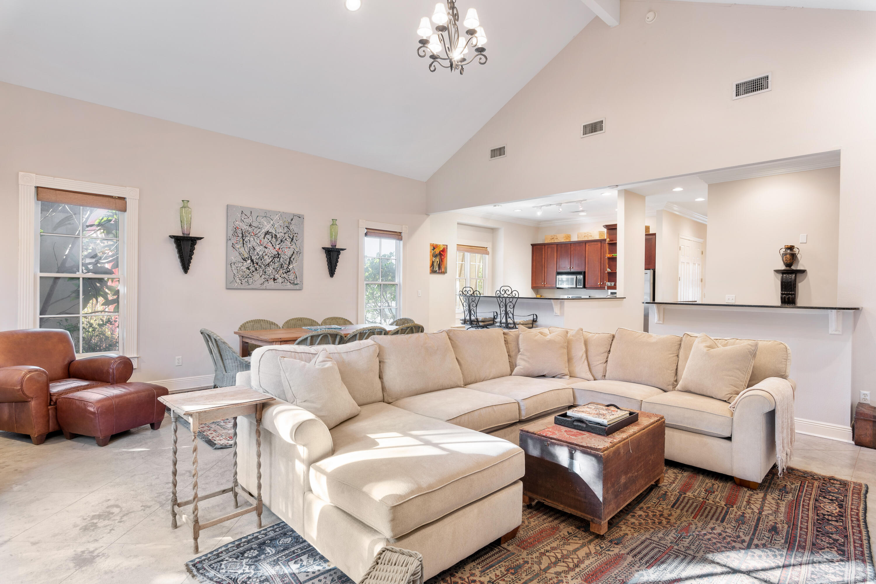 51 Rue Caribe Miramar Beach, FL 32550 - Photo 16 of 41 a living room with furniture a rug kitchen view and a chandelier