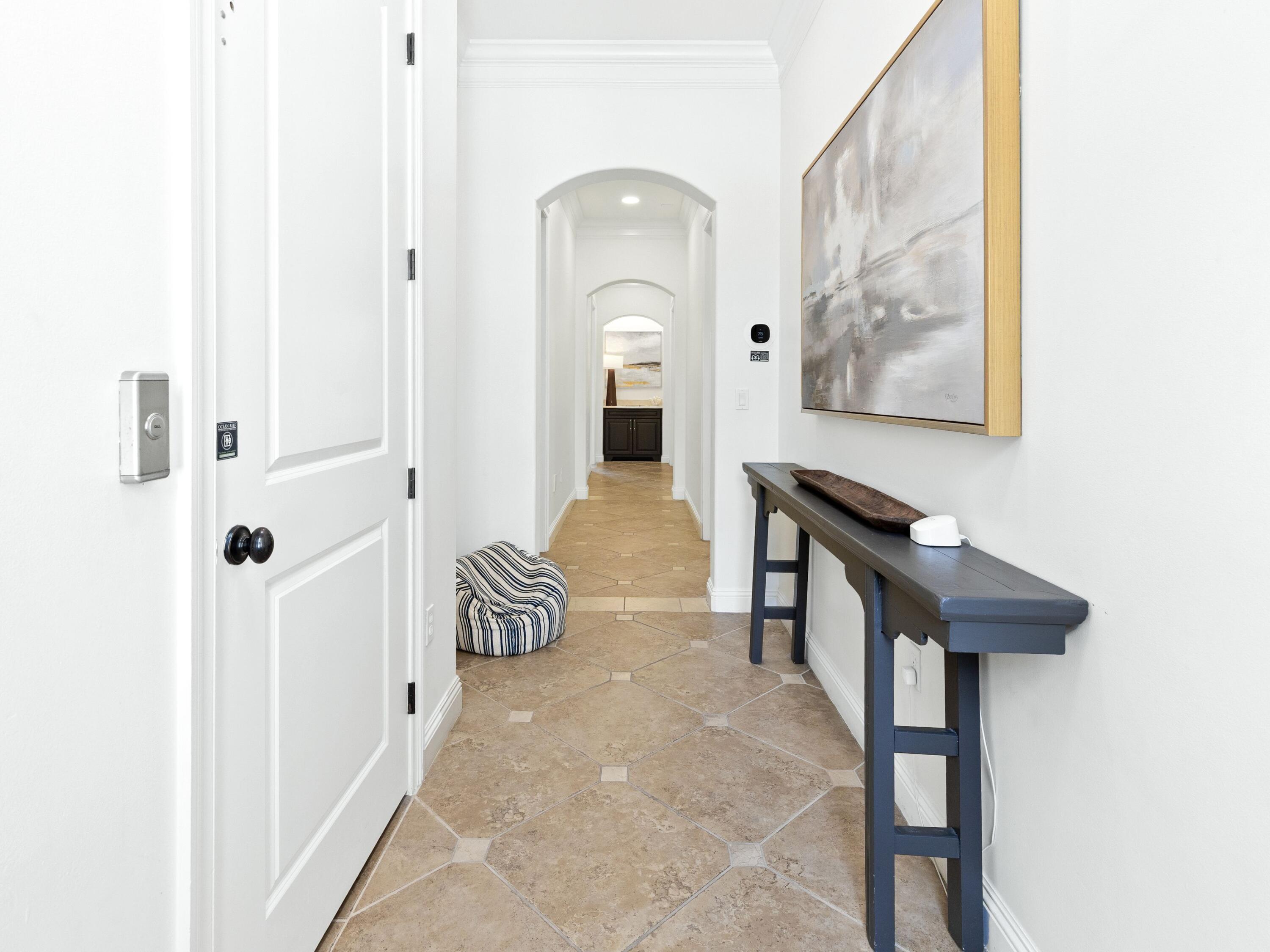 52 Tranquility Lane Destin, FL 32541 - Photo 11 of 65 a hallway with a large mirror and a bench