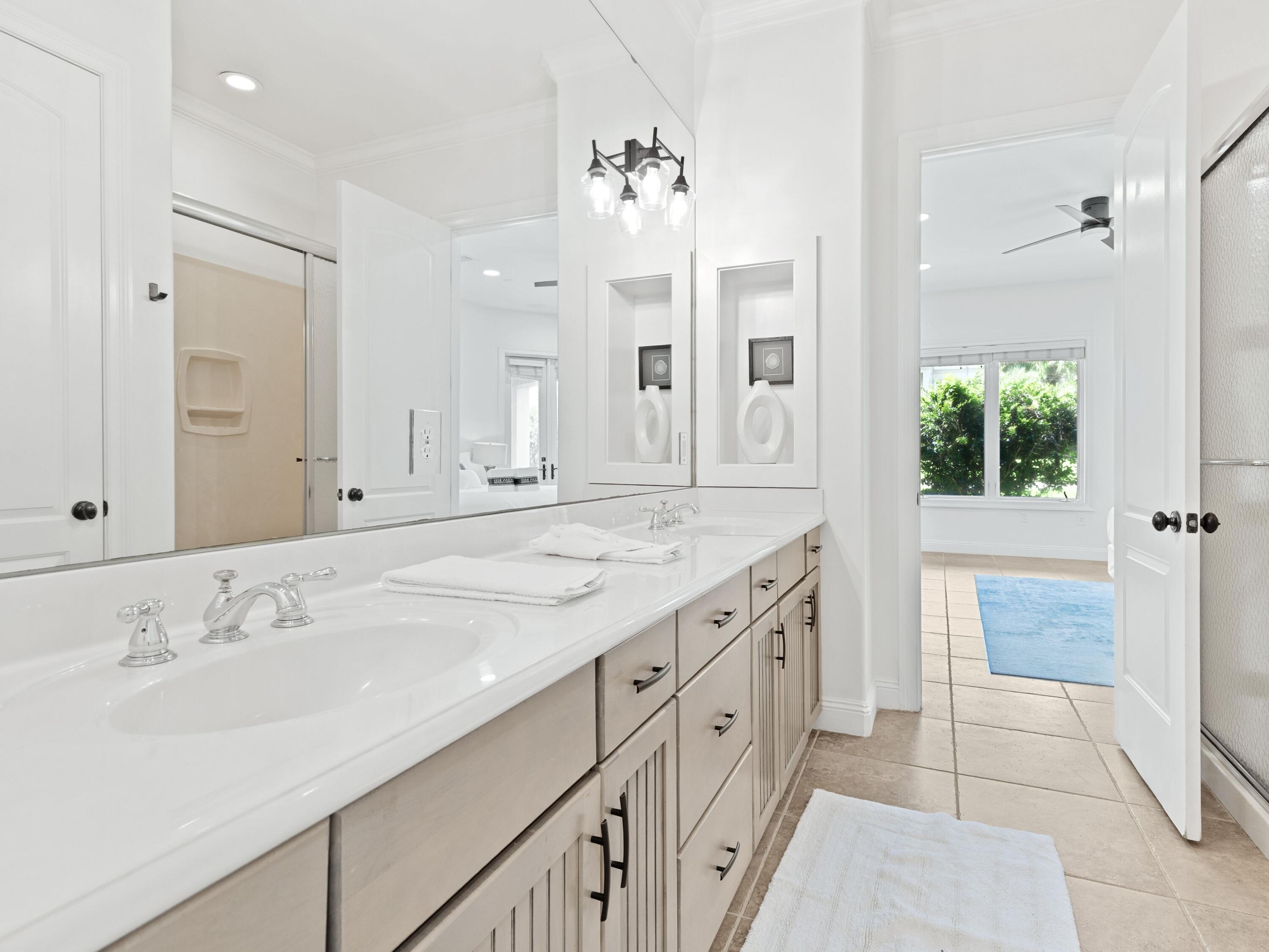 52 Tranquility Lane Destin, FL 32541 - Photo 14 of 65 a spacious bathroom with a double vanity sink mirror and shower