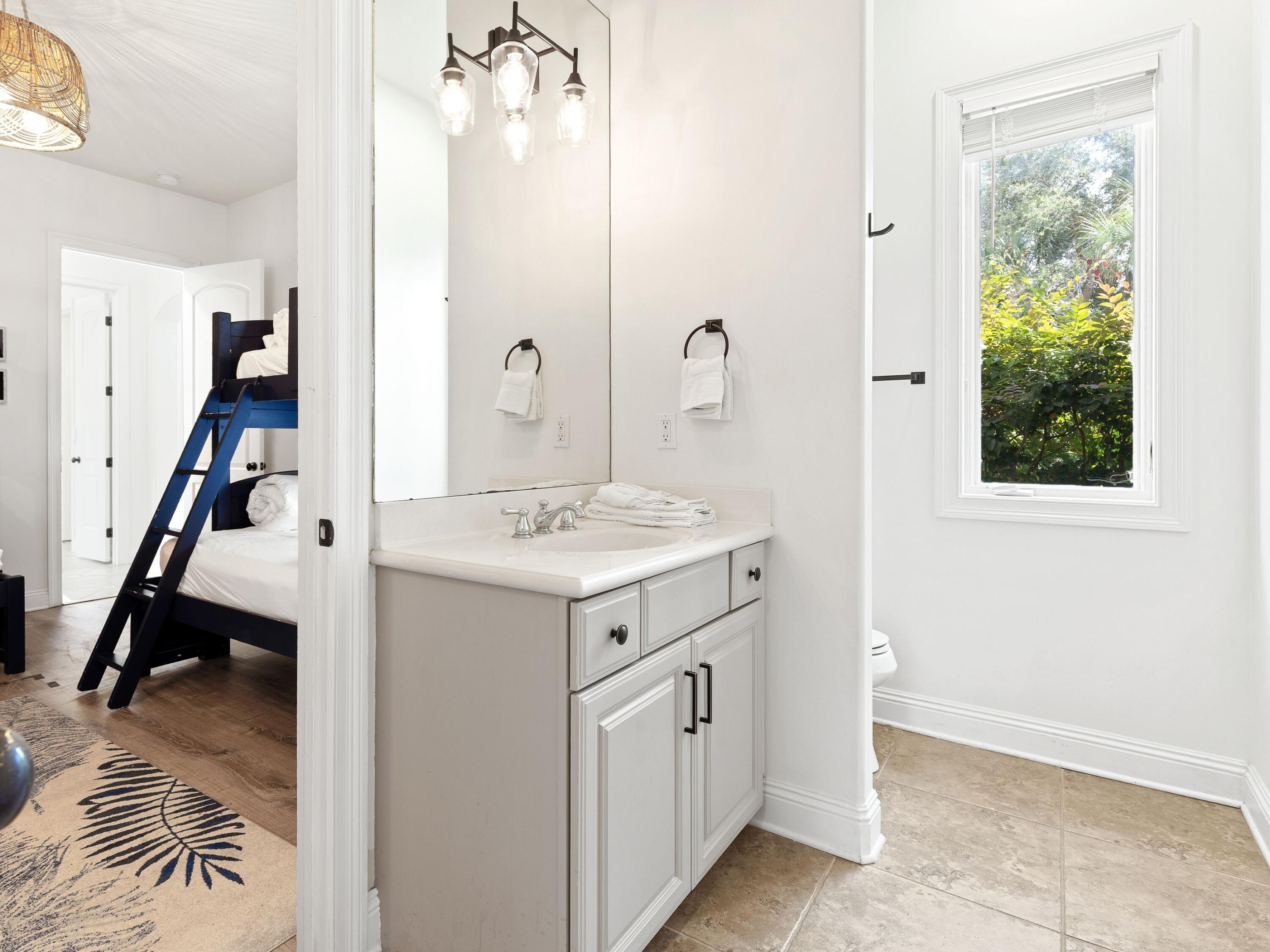 52 Tranquility Lane Destin, FL 32541 - Photo 19 of 65 a bathroom with a sink a vanity and a mirror