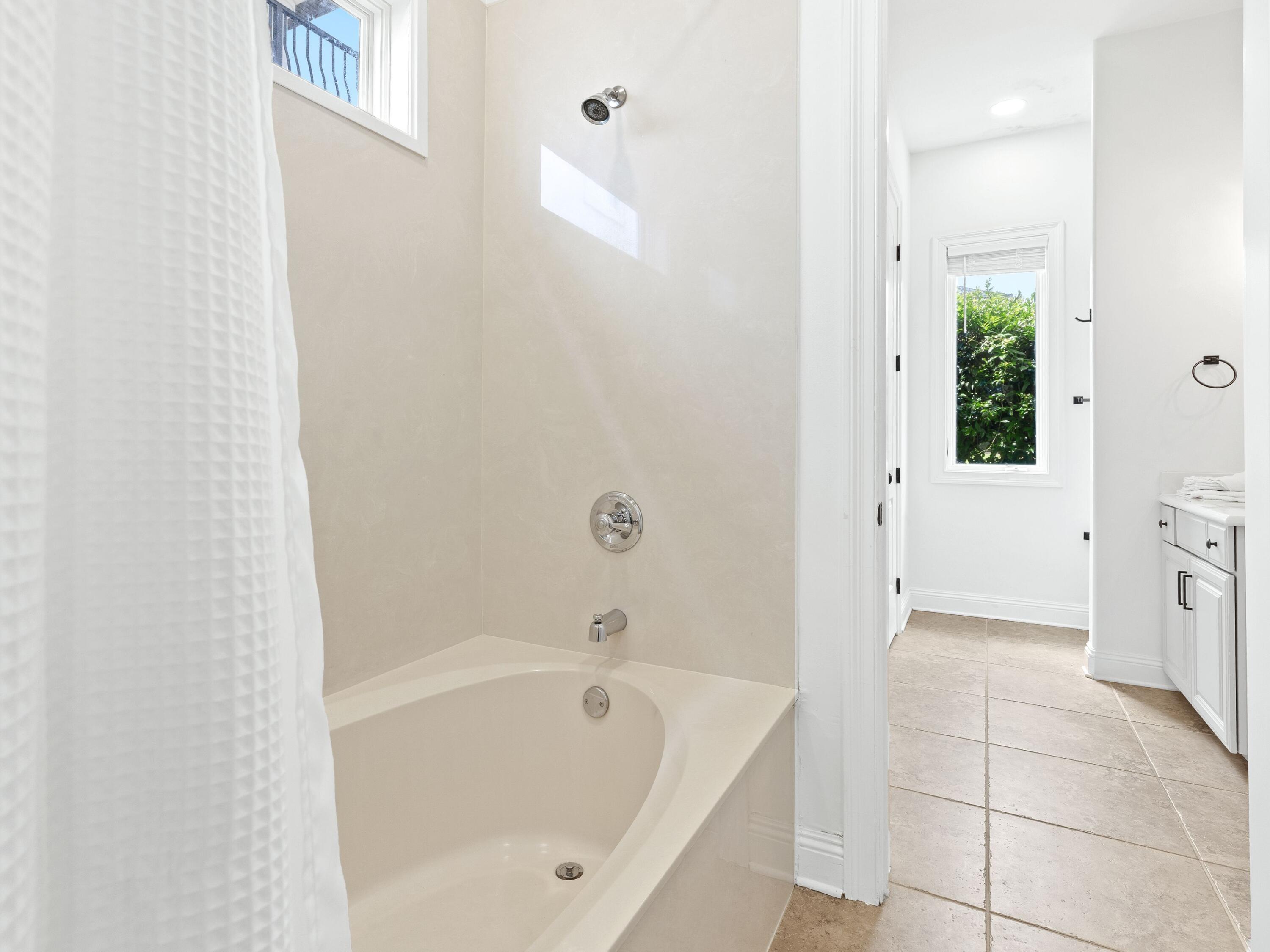 52 Tranquility Lane Destin, FL 32541 - Photo 20 of 65 a bathroom with a bathtub and a shower