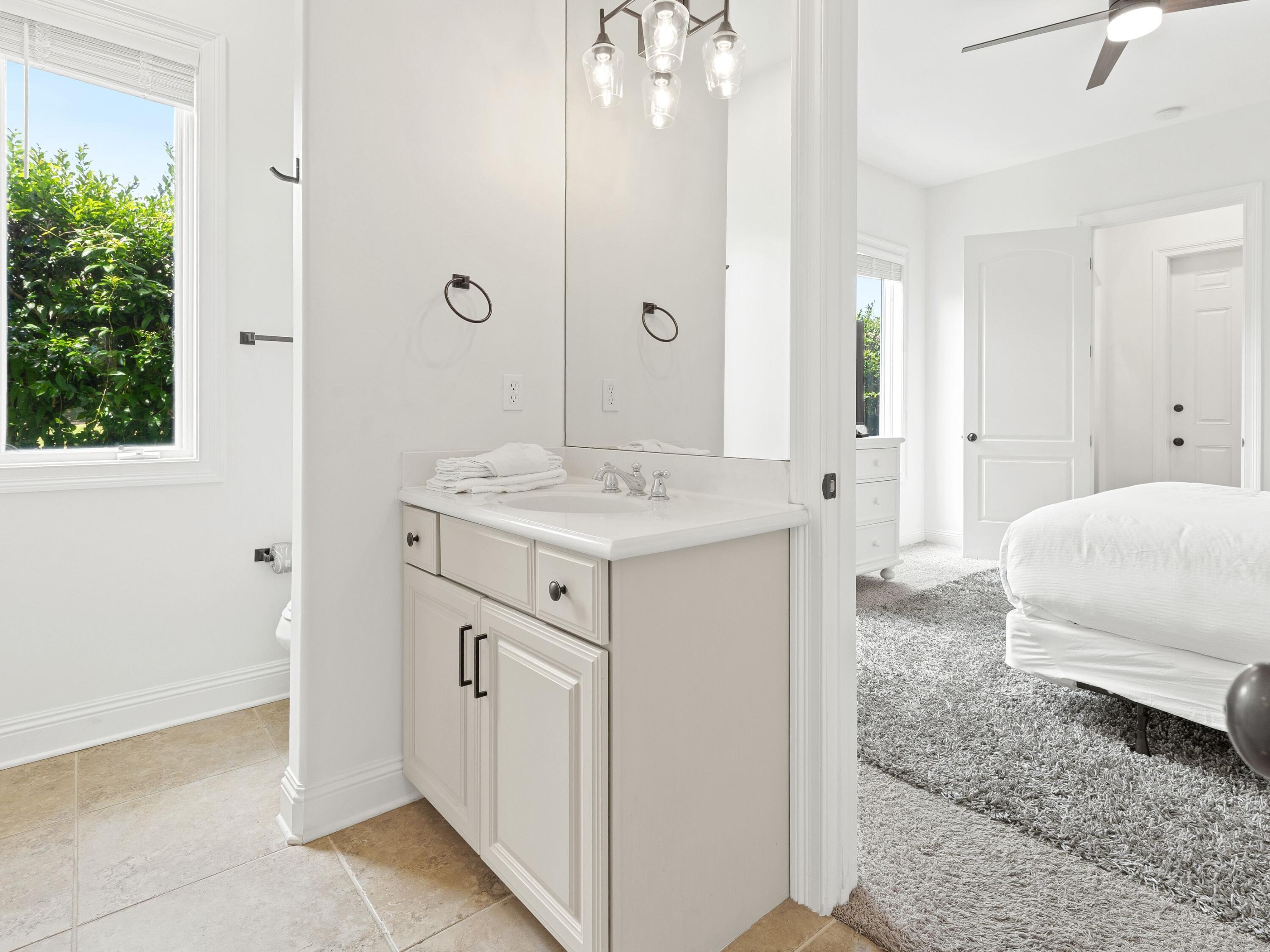 52 Tranquility Lane Destin, FL 32541 - Photo 21 of 65 a spacious bathroom with a sink and a mirror