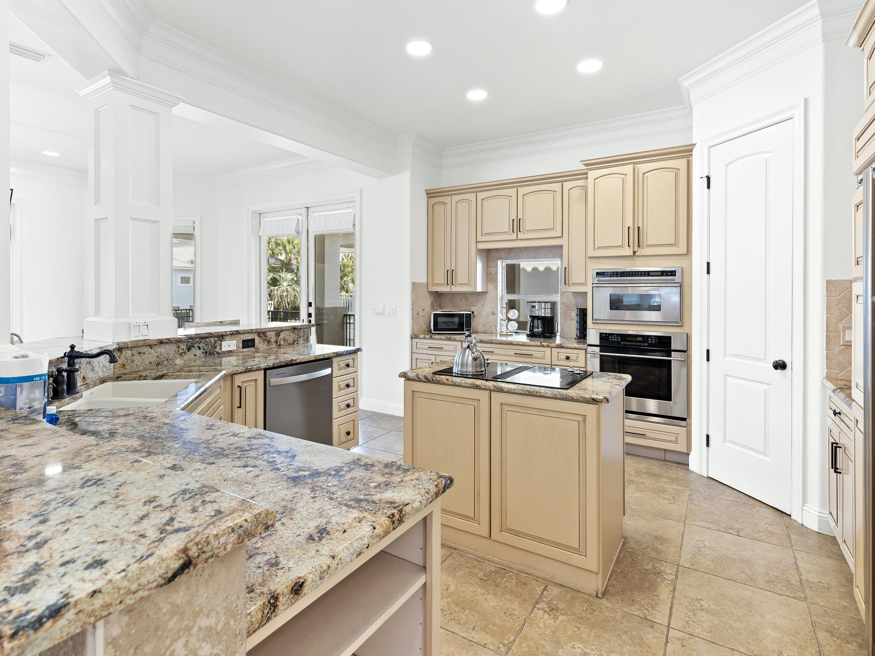 52 Tranquility Lane Destin, FL 32541 - Photo 33 of 65 a kitchen with stainless steel appliances granite countertop a sink stove and refrigerator