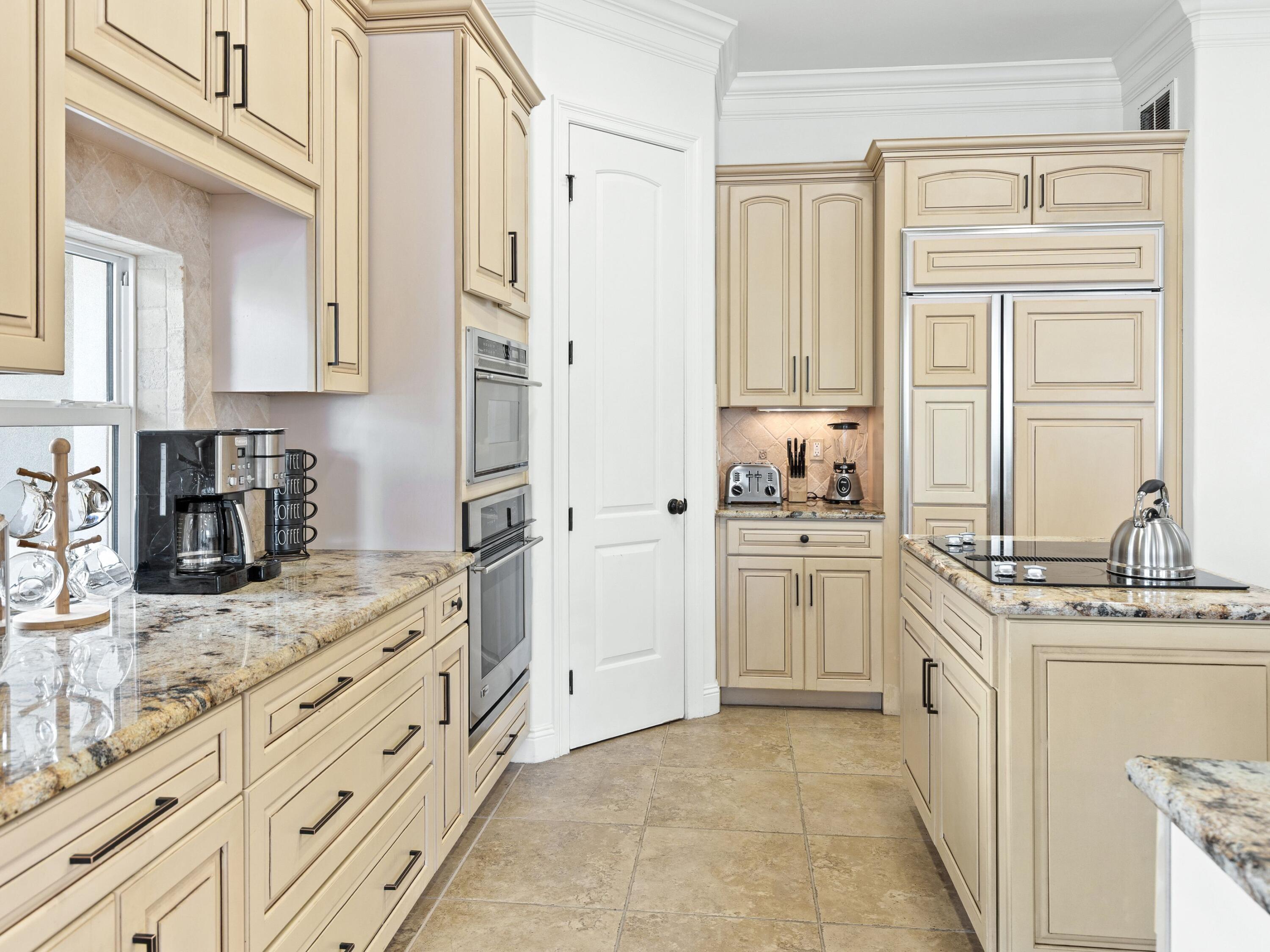52 Tranquility Lane Destin, FL 32541 - Photo 34 of 65 a kitchen with granite countertop a sink stove and refrigerator