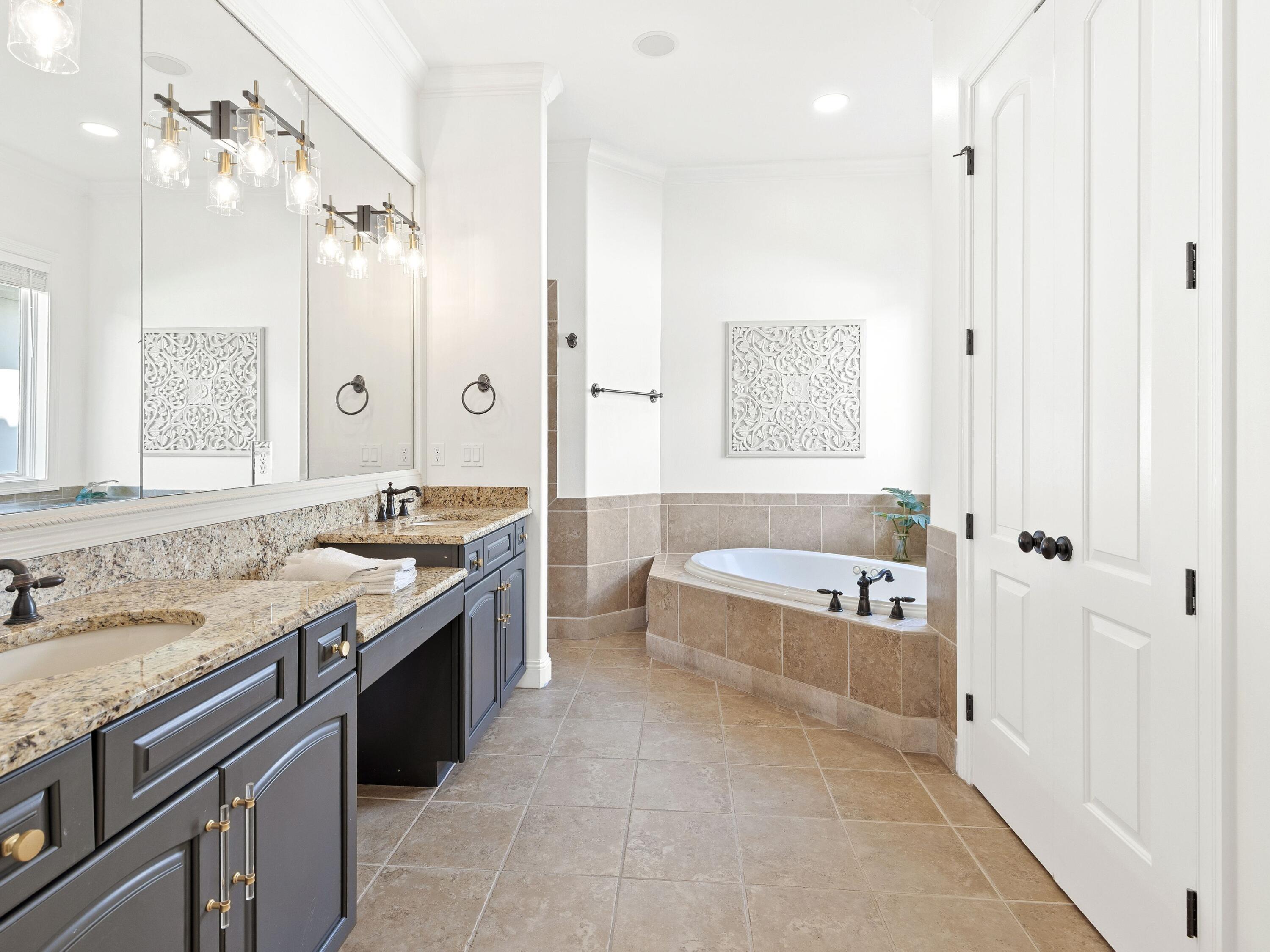 52 Tranquility Lane Destin, FL 32541 - Photo 43 of 65 a spacious bathroom with a granite countertop tub sink and mirror