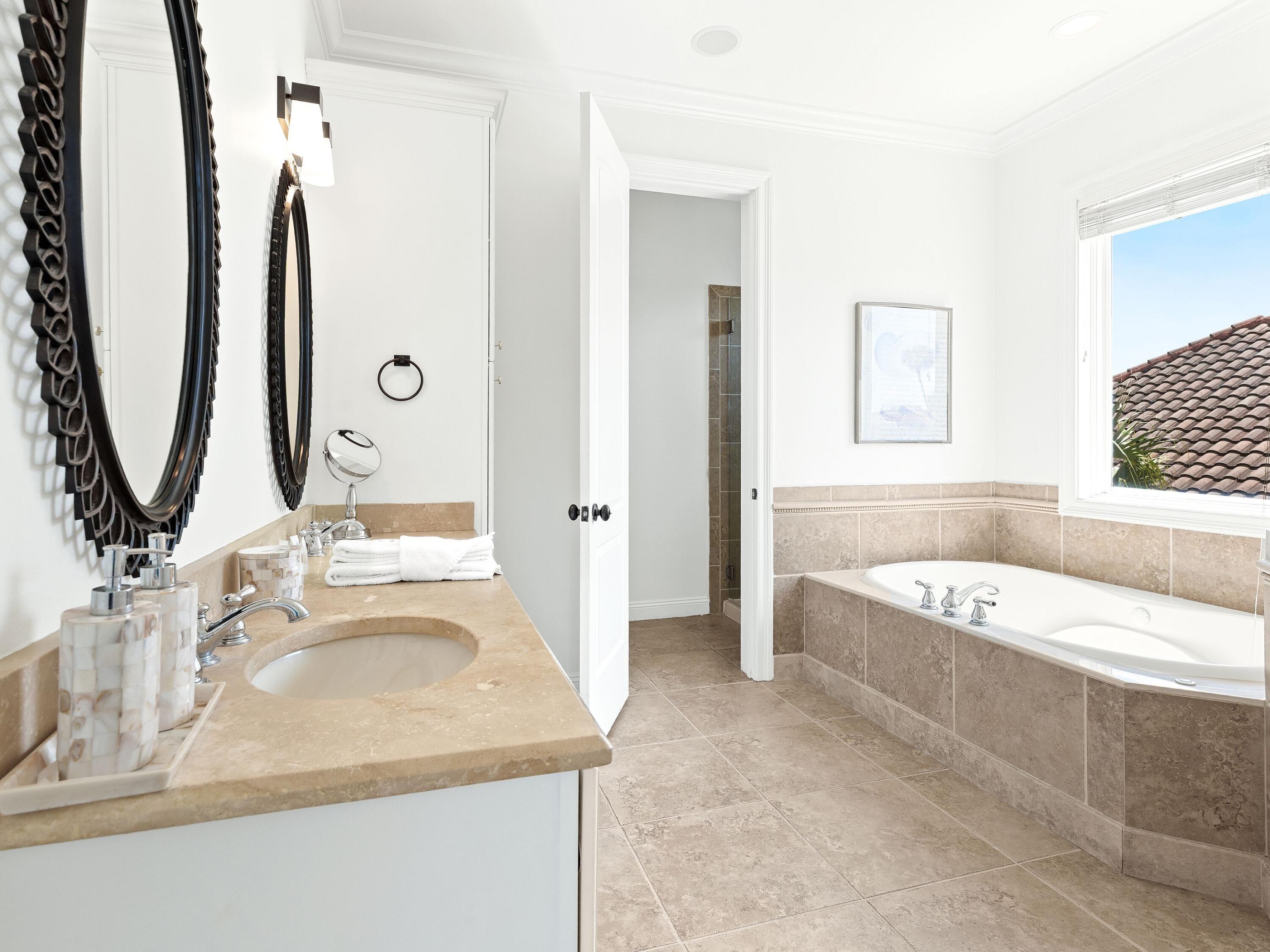 52 Tranquility Lane Destin, FL 32541 - Photo 49 of 65 a bathroom with a granite countertop tub sink and mirror