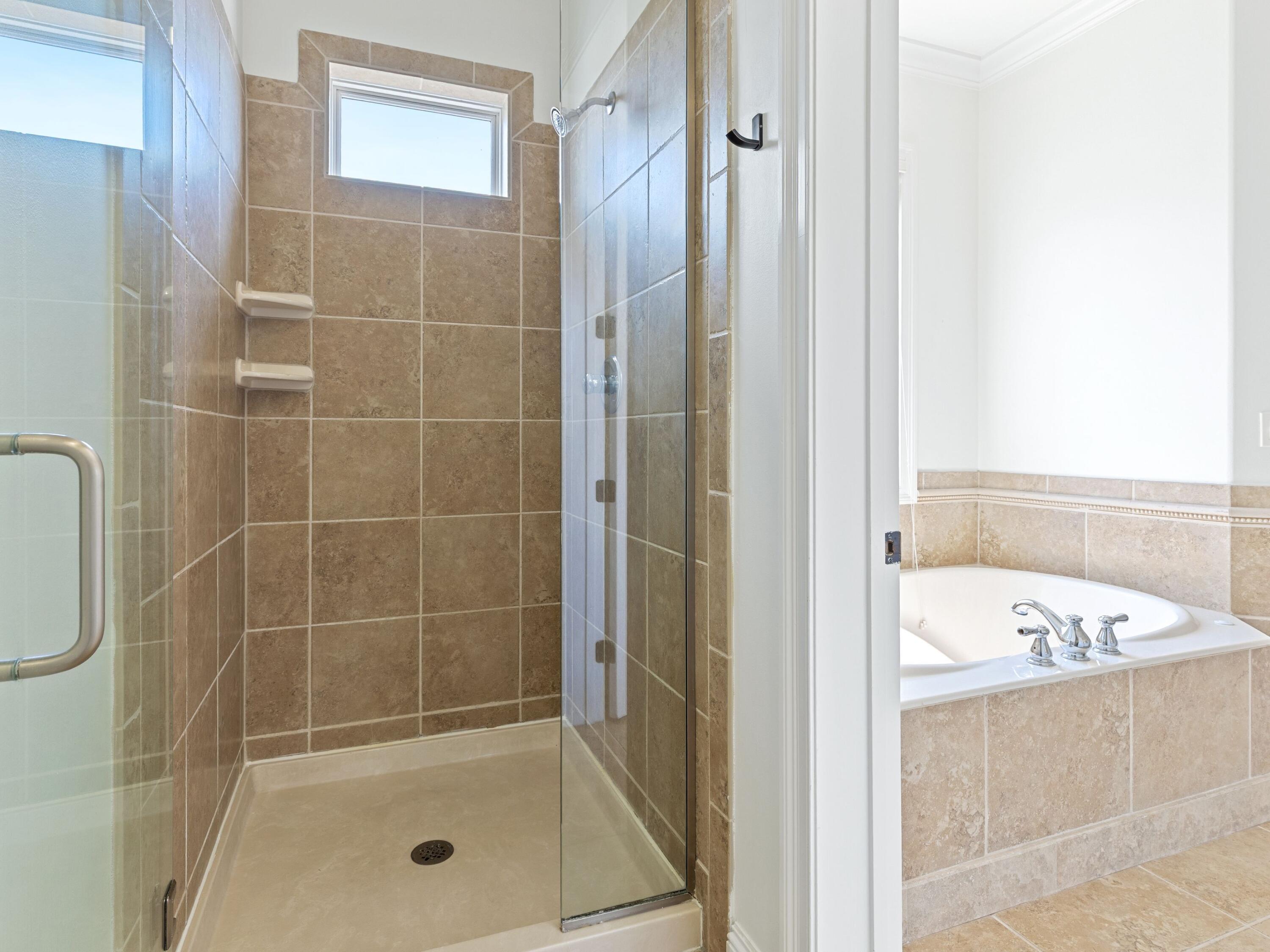 52 Tranquility Lane Destin, FL 32541 - Photo 50 of 65 a bathroom with a bathtub and a shower
