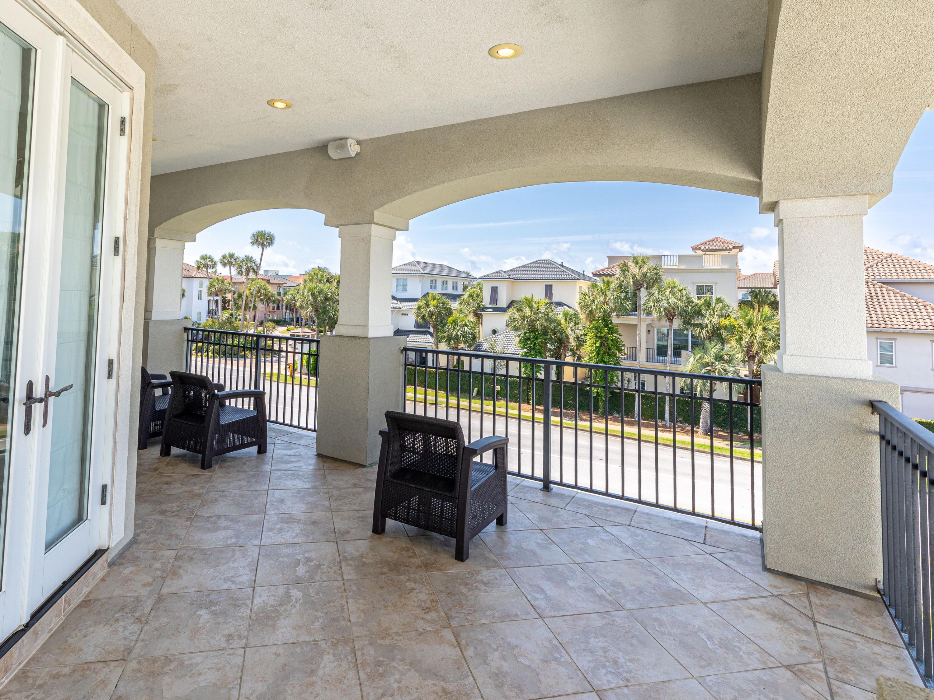 52 Tranquility Lane Destin, FL 32541 - Photo 52 of 65 a view of a balcony with furniture and floor to ceiling window