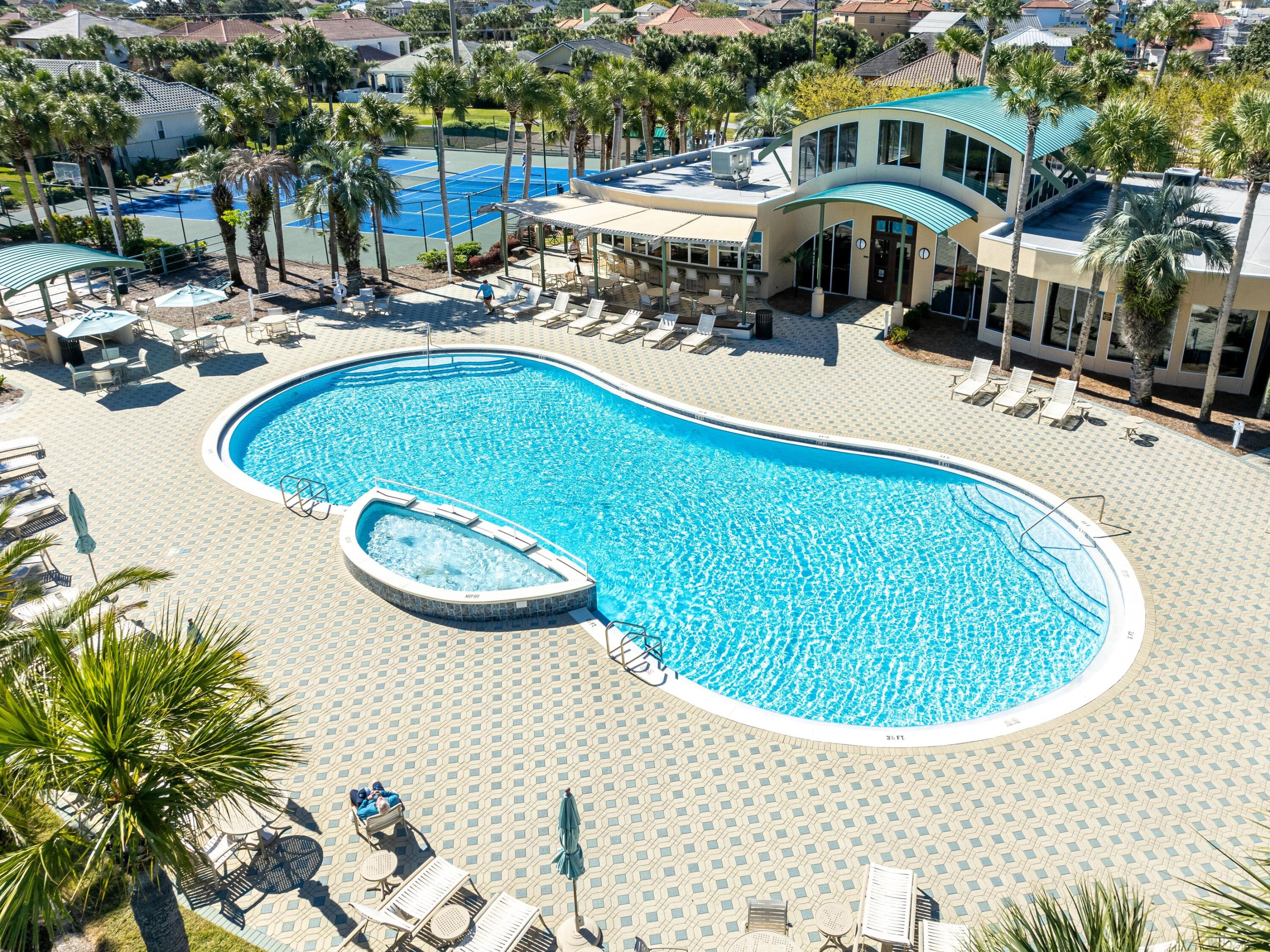 52 Tranquility Lane Destin, FL 32541 - Photo 56 of 65 a view of a swimming pool with a patio and plants