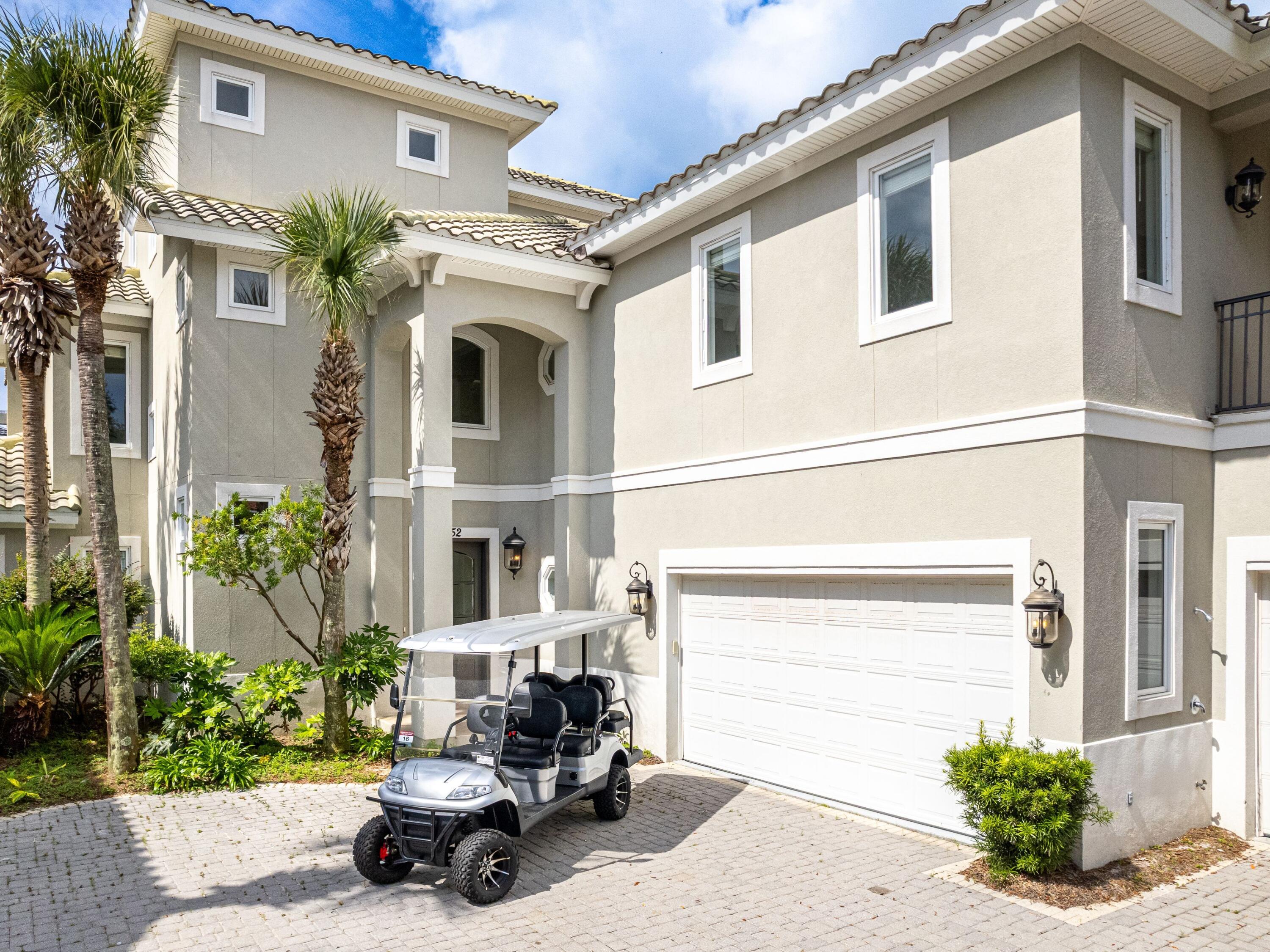 52 Tranquility Lane Destin, FL 32541 - Photo 8 of 65 a car parked in front of white house