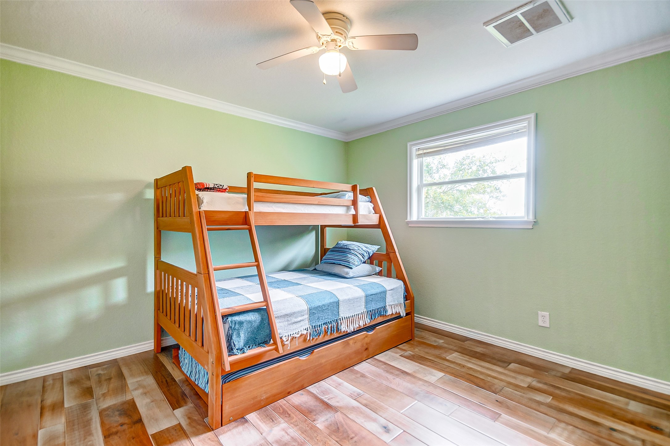 2101 7th Street High Island, TX 77650 - Photo 19 of 33 a bedroom with a bunk bed and a chandelier
