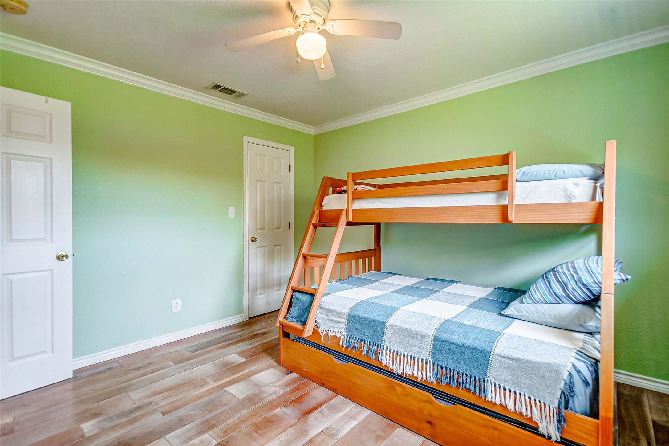 2101 7th Street High Island, TX 77650 - Photo 20 of 33 a bedroom with a bed and a chandelier