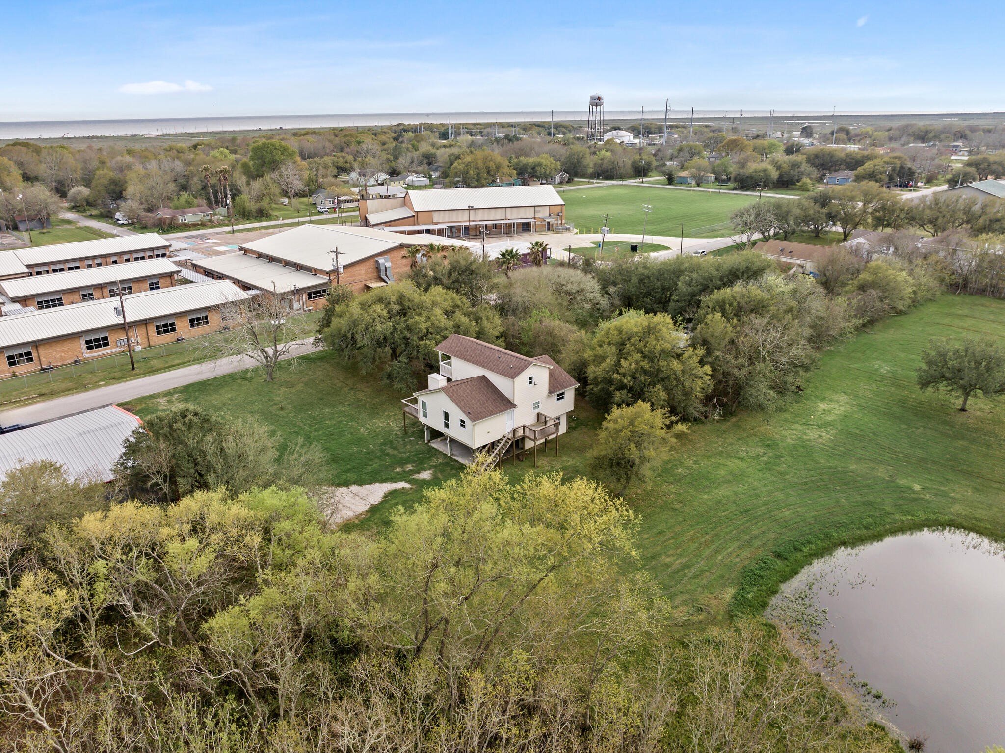 2101 7th Street High Island, TX 77650 - Photo 30 of 33 an aerial view of residential houses with outdoor space and trees