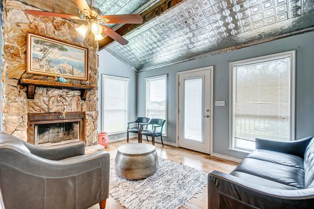 a living room with furniture a window and a fireplace