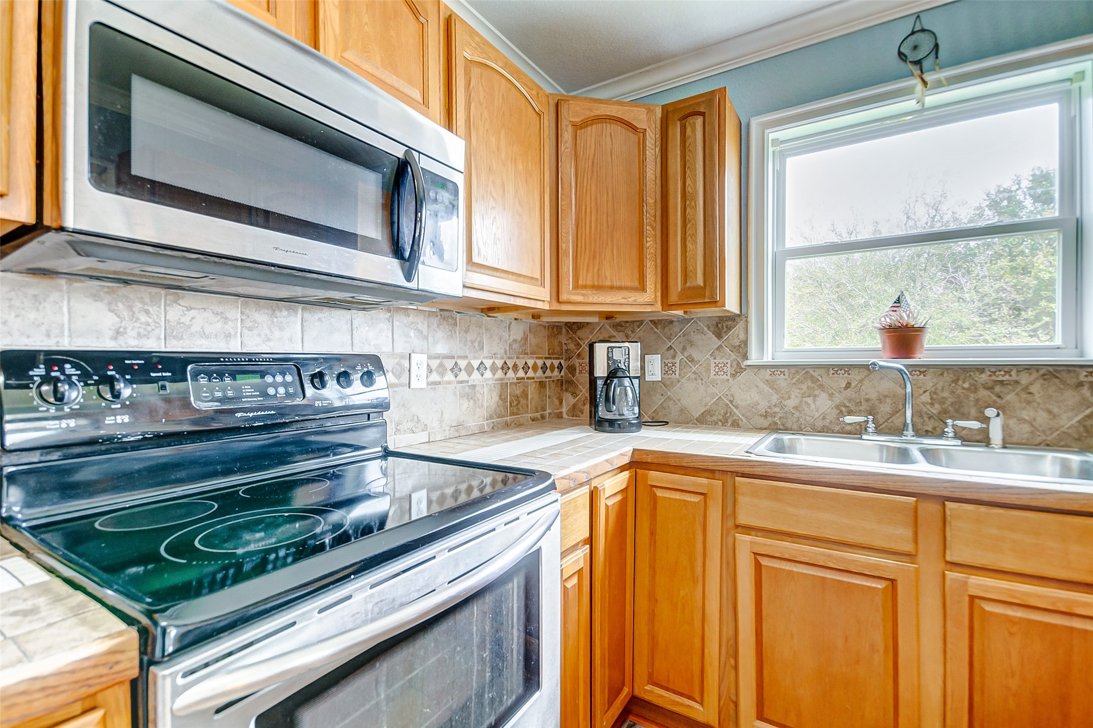 2101 7th Street High Island, TX 77650 - Photo 10 of 33 a kitchen with a stove microwave and sink