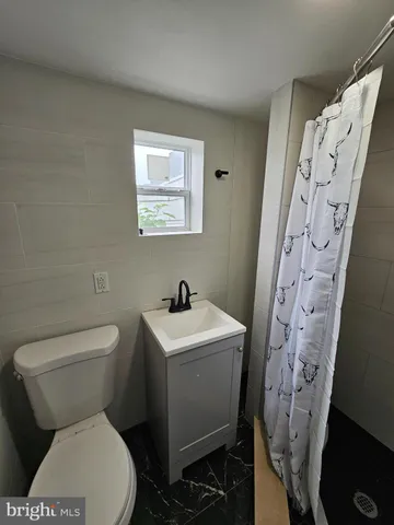 a white toilet sitting next to a bathroom sink