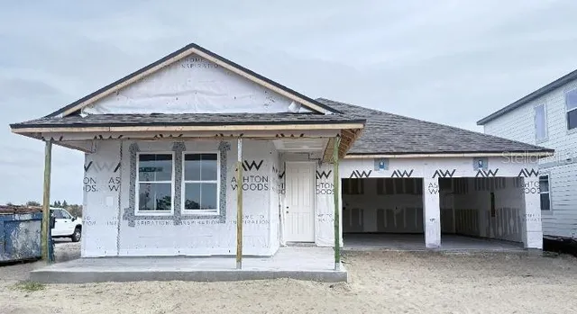 a view of a hallway with a livingroom and a window