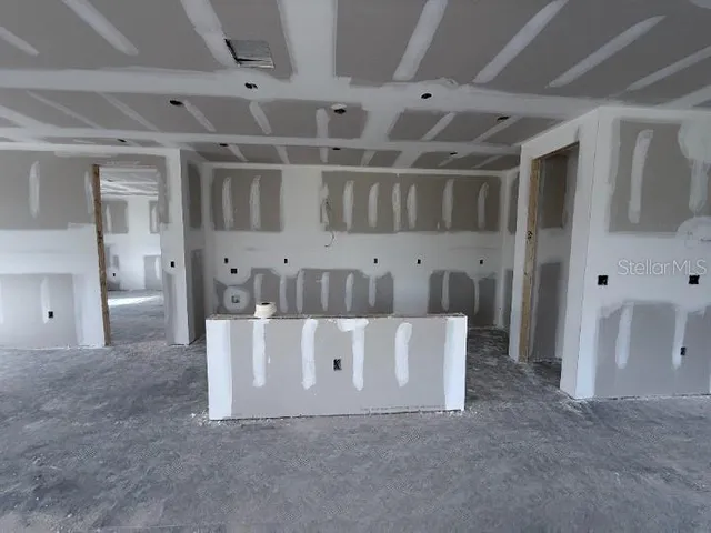 a view of an empty room with window and fireplace