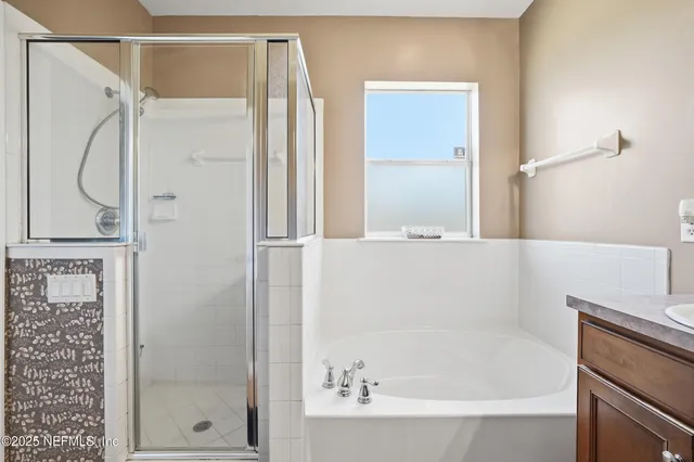 a bathroom with a double vanity sink and a mirror