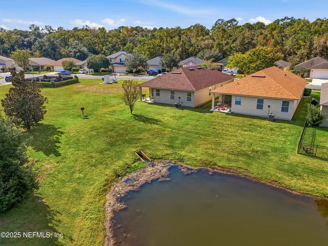 a view of a lake with houses in the back