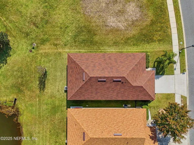 an aerial view of a house with a swimming pool