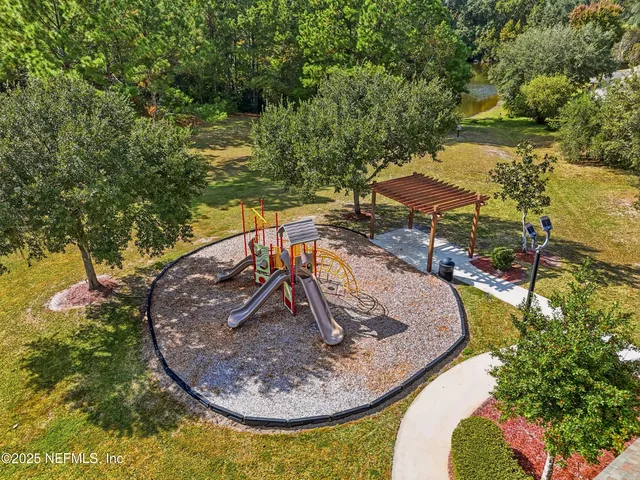 a view of a swimming pool with an outdoor seating and a garden