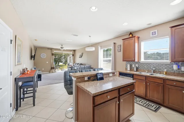 a kitchen with a stove a sink and a refrigerator