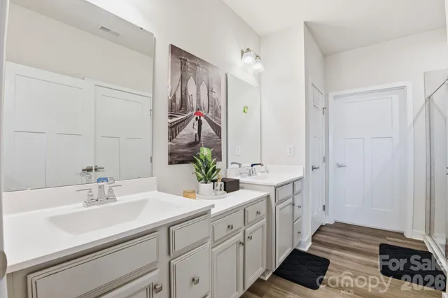 a bathroom with a double vanity sink and a mirror