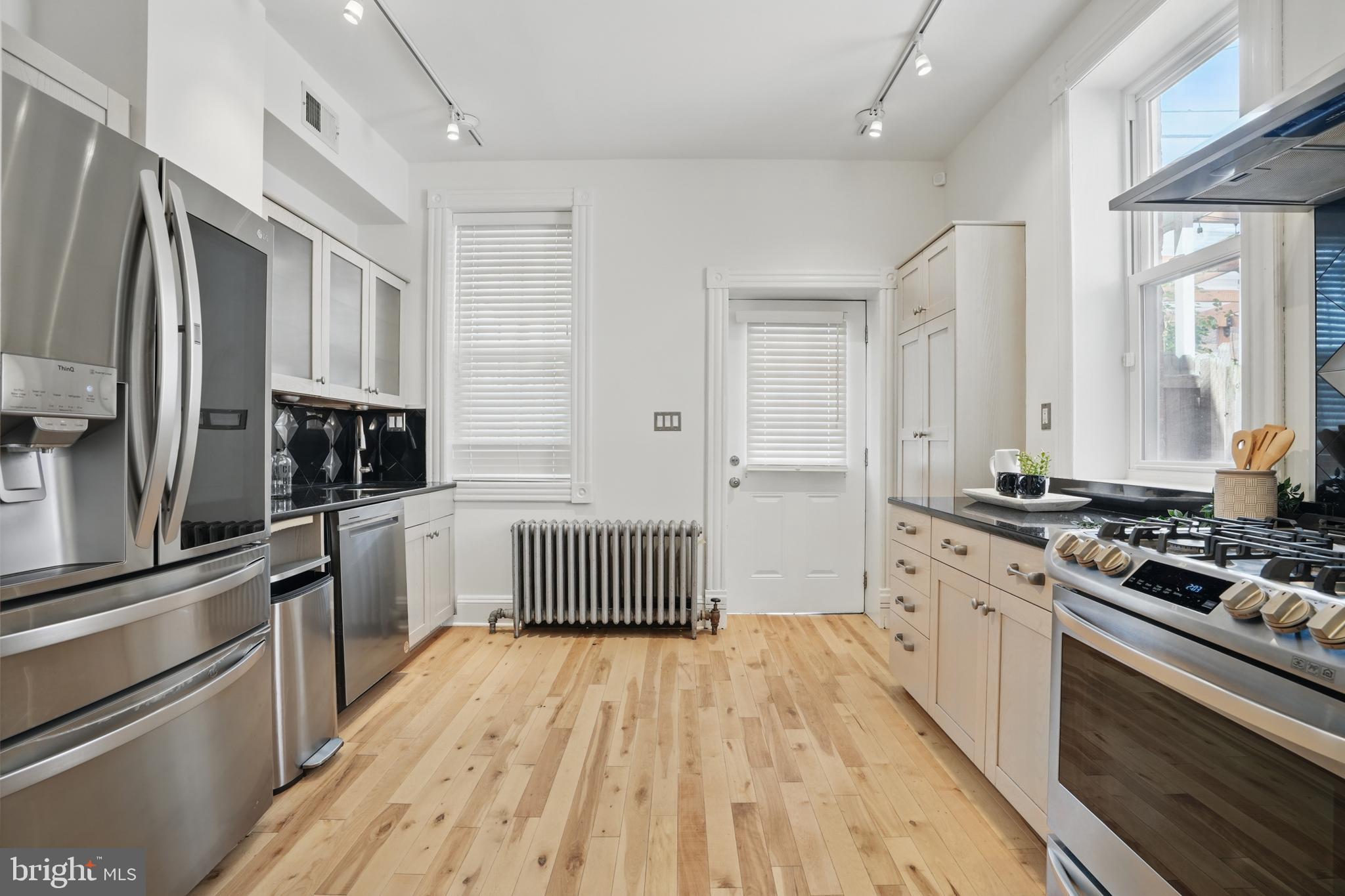 136 R Street Northeast Washington, DC 20002 - Photo 12 of 36 a kitchen with stainless steel appliances a refrigerator stove and sink