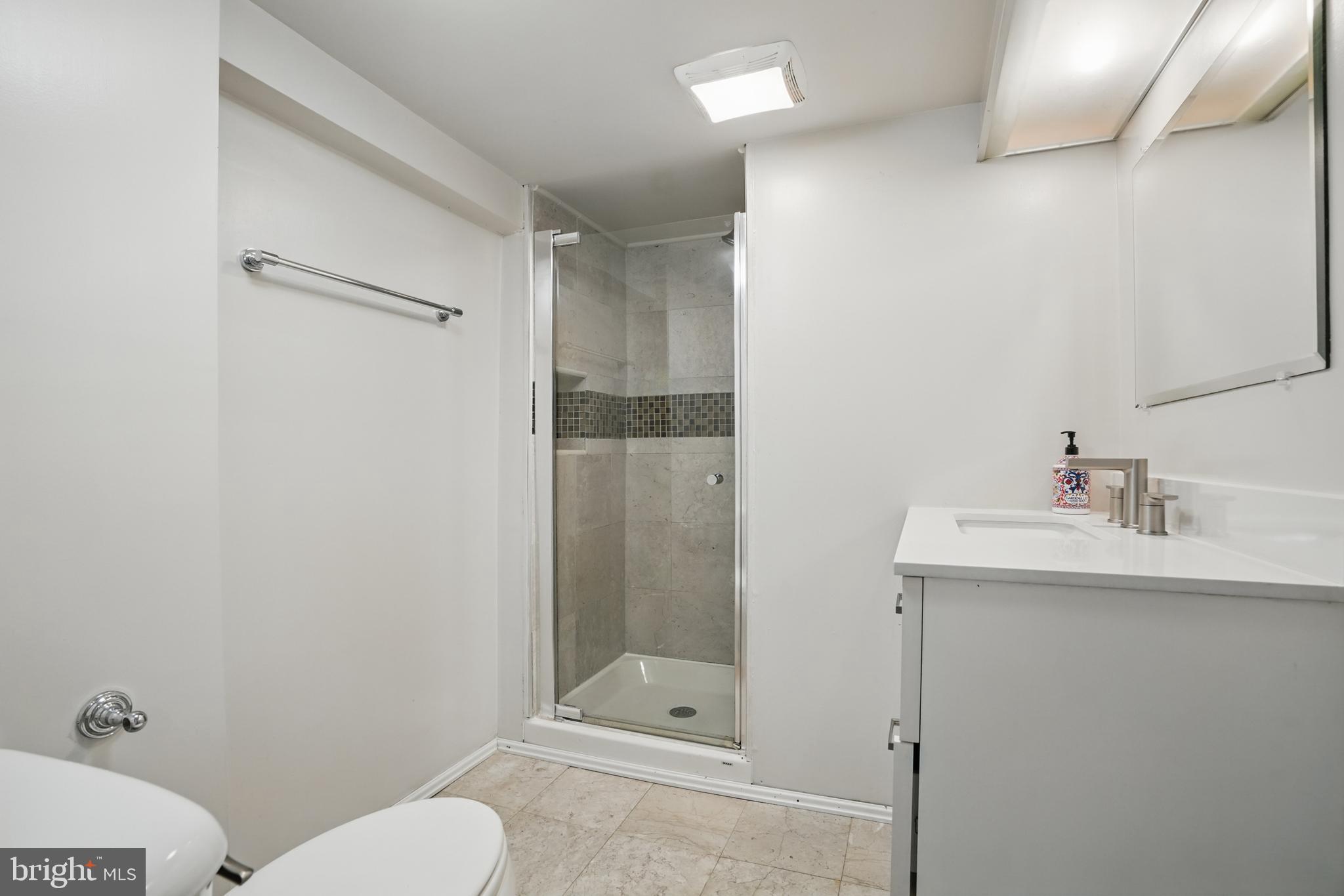 136 R Street Northeast Washington, DC 20002 - Photo 30 of 36 a bathroom with a sink toilet and shower