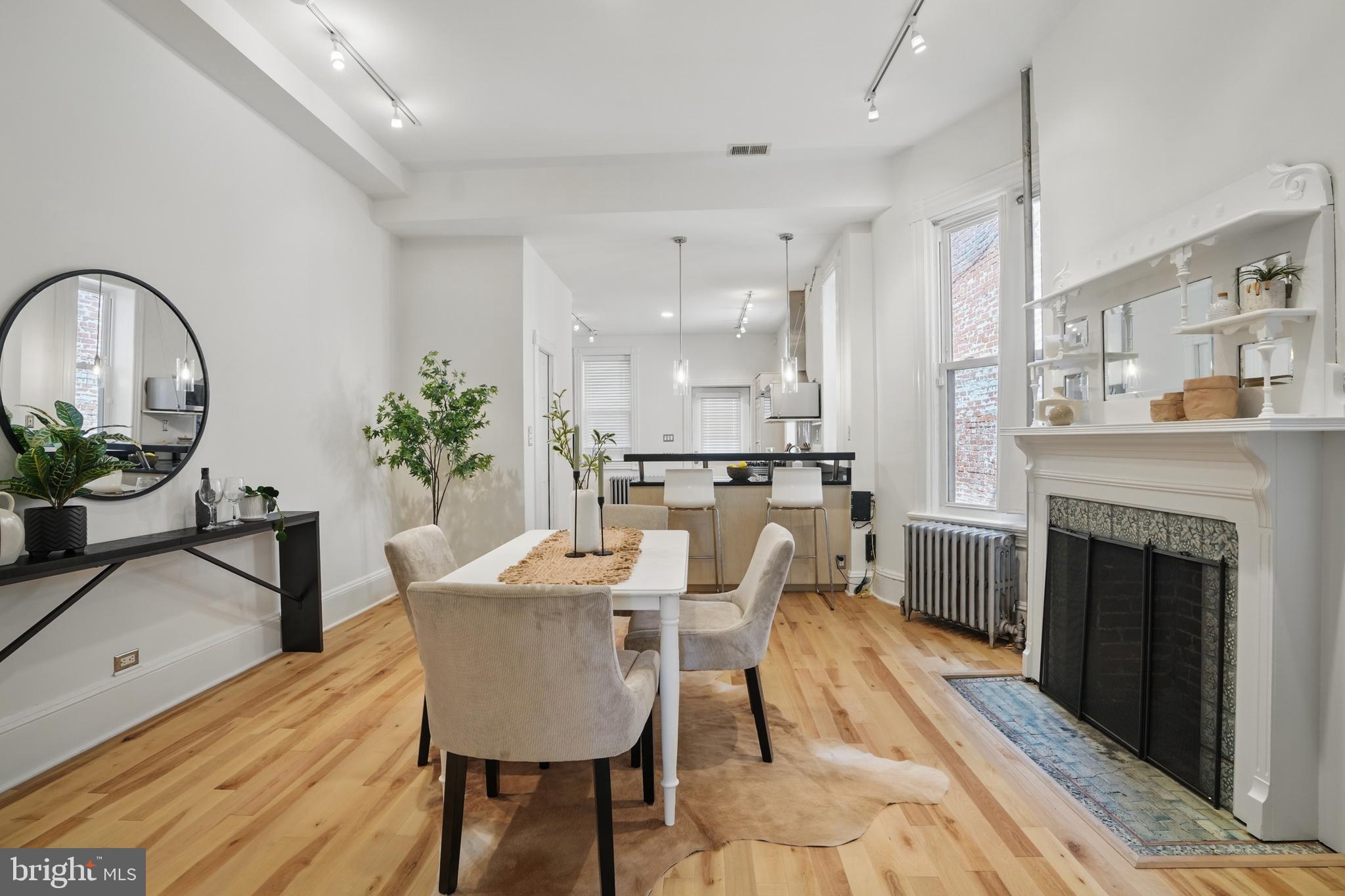 136 R Street Northeast Washington, DC 20002 - Photo 9 of 36 a dining room with furniture potted plants and wooden floor