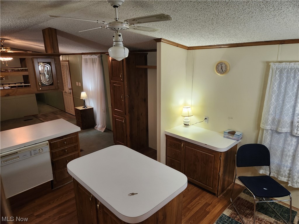 3895 Middletown Road East Youngstown, OH 44514 - Photo 15 of 28 Kitchen featuring dark brown cabinets, ceiling fan, a textured ceiling, white dishwasher, and dark hardwood / wood-style floors