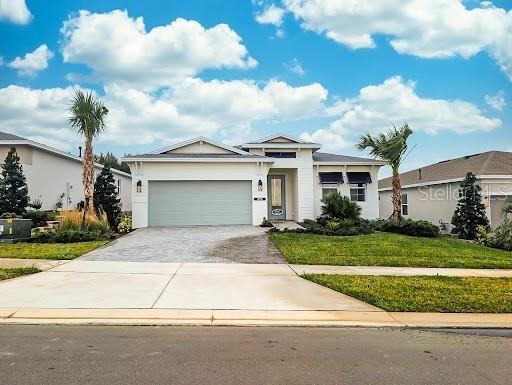1725 Point Grace Road Tavares, FL 32778 - Photo 1 of 1 a front view of a house with a yard and garage