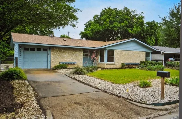 a front view of a house with a garden and porch