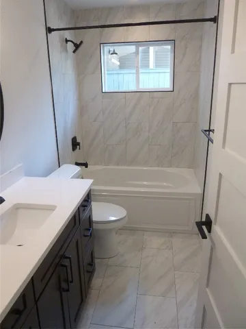 a bathroom with a sink a toilet and a shower