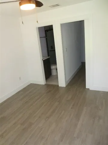 a view of a room with wooden floor