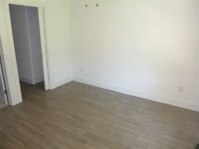 an empty room with wooden floor