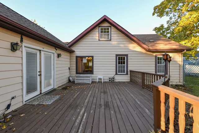 a view of backyard with wooden fence and deck