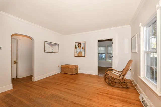 a view of a livingroom with wooden floor and furniture