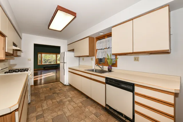 a kitchen with granite countertop a sink and a stove top oven