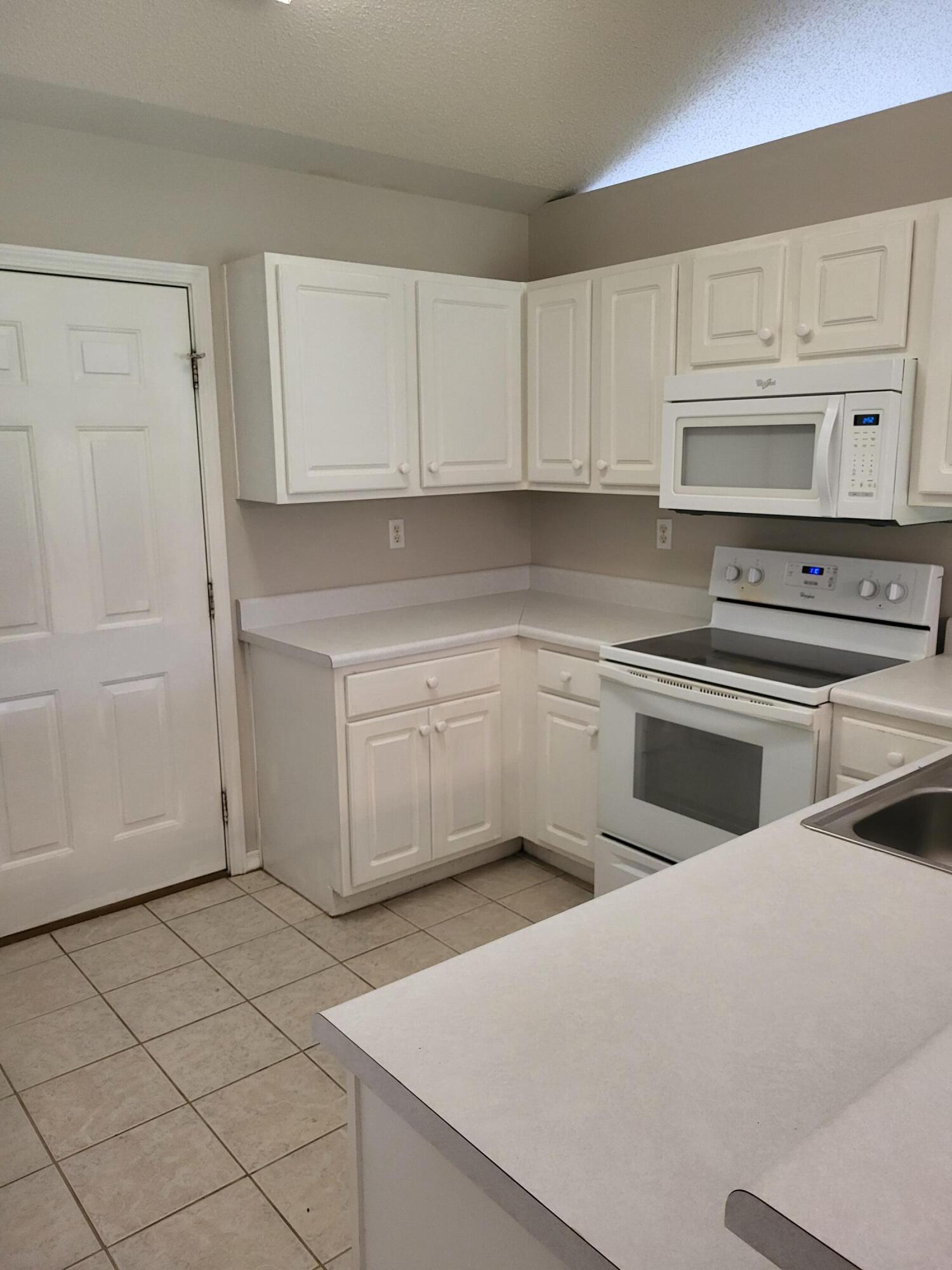 4491 Old Antioch Road Crestview, FL 32536 - Photo 5 of 15 a kitchen with white cabinets stainless steel appliances and sink