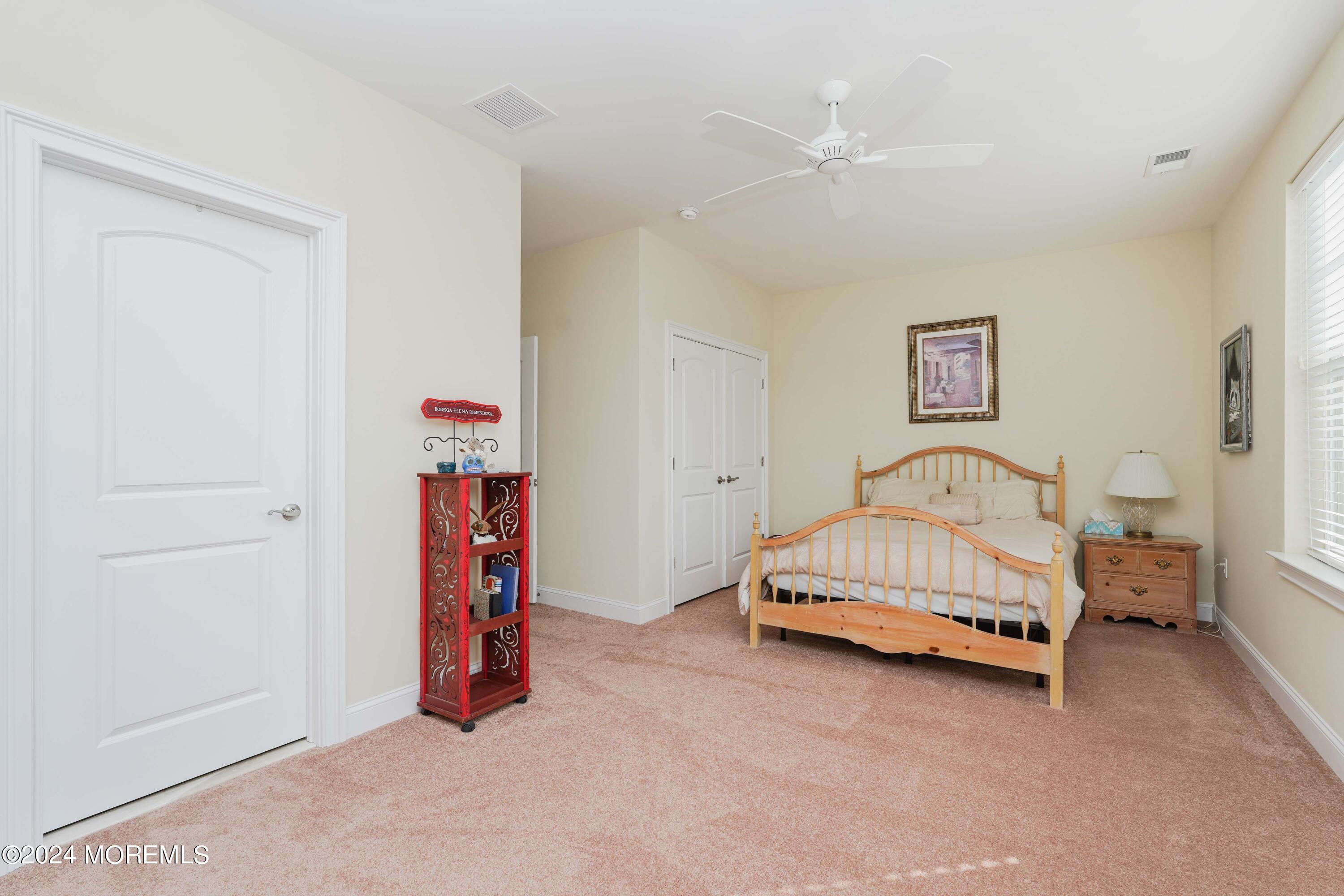 32 Abbey Road Tinton Falls, NJ 07753 - Photo 24 of 32 a bed room with a bed and a chair