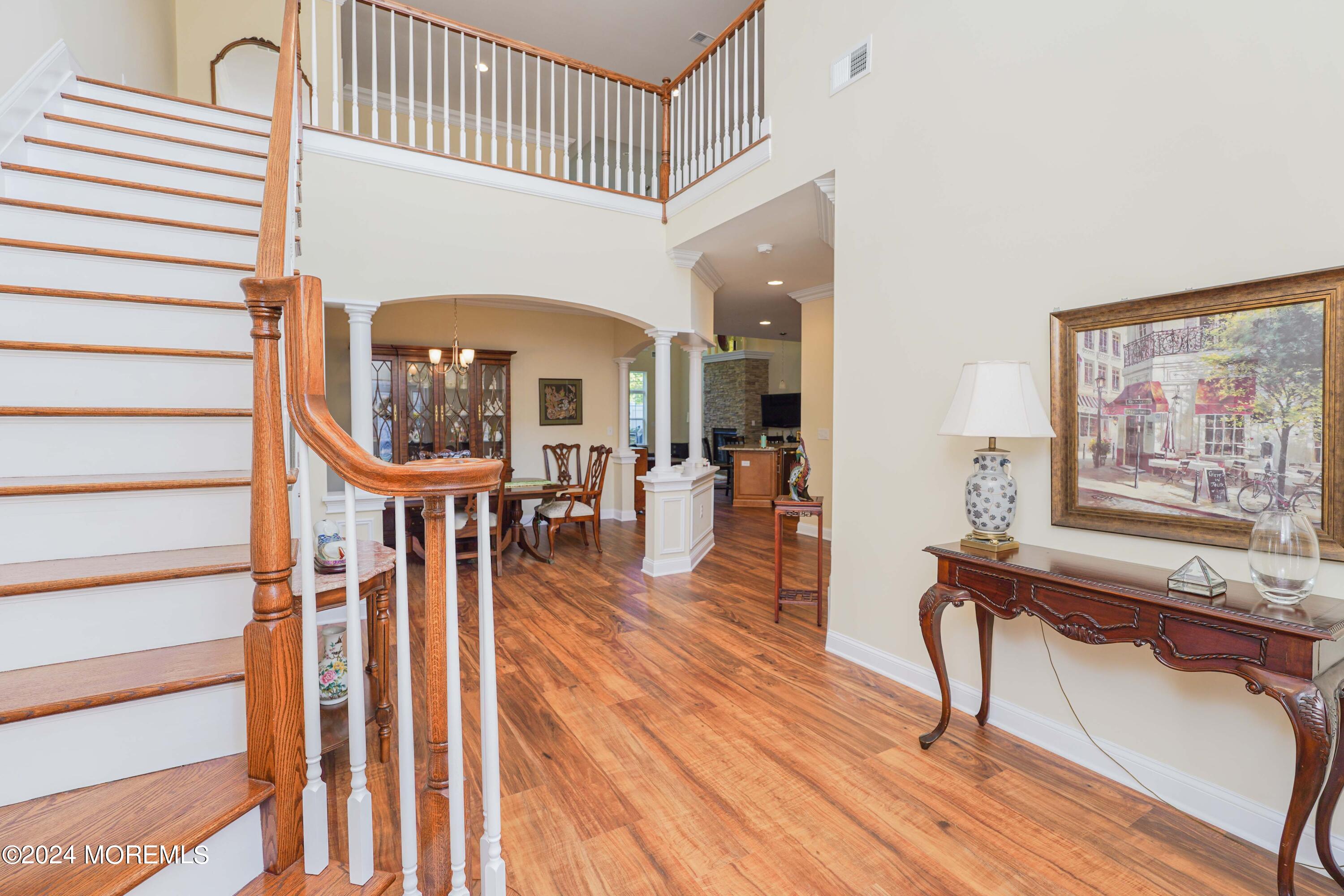 32 Abbey Road Tinton Falls, NJ 07753 - Photo 6 of 32 a view of a living room and entryway with wooden floor