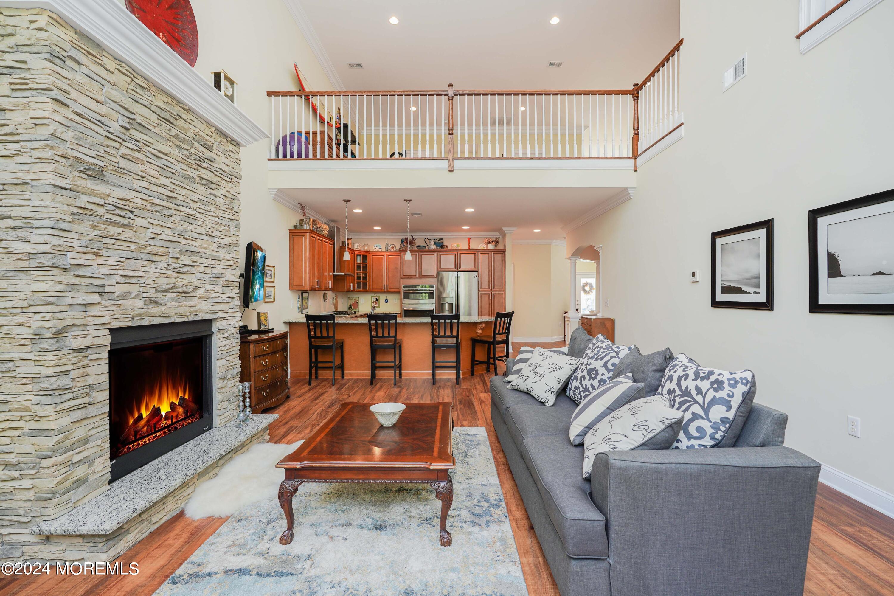 32 Abbey Road Tinton Falls, NJ 07753 - Photo 7 of 32 a living room with furniture a flat screen tv and a fireplace