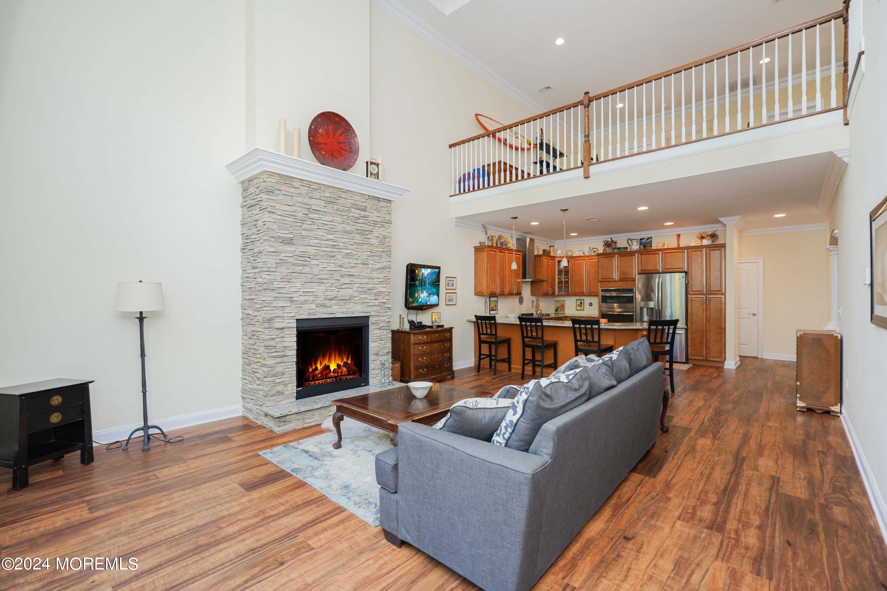 32 Abbey Road Tinton Falls, NJ 07753 - Photo 8 of 32 a living room with furniture a fireplace and a flat screen tv