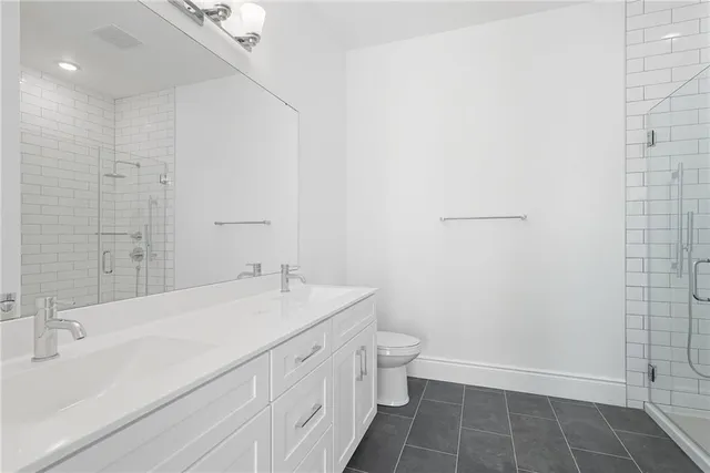 a bathroom with a sink a toilet and a shower