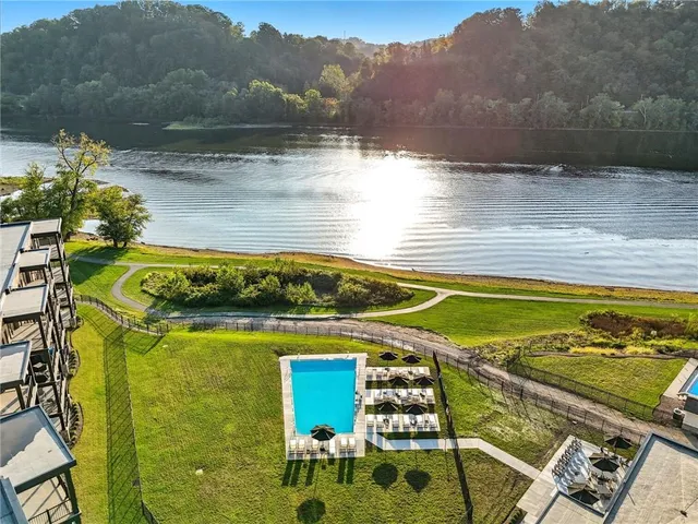 an aerial view of residential houses with outdoor space and swimming pool